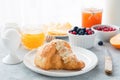 Continental breakfast croissant, honey, jam, berries and egg Royalty Free Stock Photo