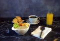 Continental breakfast, a cup of oatmeal with slices of fruit, orange juice, black coffee and two fresh croissants on a plate Royalty Free Stock Photo