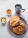 Continental breakfast with French chocolate croissants, butter, Royalty Free Stock Photo