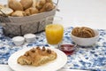 Continental breakfast with fresh croissants, biscuits, bread, jam and orange juice on table Royalty Free Stock Photo