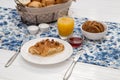 Continental breakfast with fresh croissants, biscuits, bread, jam and orange juice on table Royalty Free Stock Photo