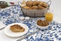 Continental breakfast with fresh croissants, biscuits, bread, jam and orange juice on table Royalty Free Stock Photo