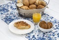 Continental breakfast with fresh croissants, biscuits, bread, jam and orange juice on table Royalty Free Stock Photo