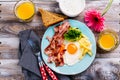 Continental breakfast with fried eggs, bacon and drinks Royalty Free Stock Photo
