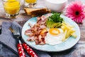Continental breakfast with fried eggs, bacon and drinks Royalty Free Stock Photo