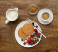 Continental breakfast of a Pancakes, fruit, and coffee, shot on
