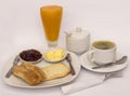 Continental breakfast: papaya juice, coffee, toasted bread, jam and butter. Royalty Free Stock Photo