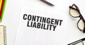 CONTINGENT LIABILITY on paper with glasses and pen