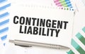 CONTINGENT LIABILITY on white paper sheet on charts