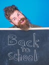 Continue your education with us. Teacher invites to continue studying. New semester in school. Teacher bearded man