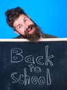 Continue your education with us. Teacher invites to continue studying. New semester in school. Teacher bearded man