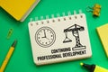 Continuing Professional Development CPD is shown using the text and picture of clock Royalty Free Stock Photo