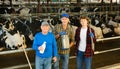 Continuity of generations - portrait of farmers of different ages against the backdrop of cowshed