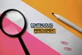 Continuous Improvement text on sticky notes with color office desk concept