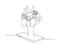 continuous line drawing of a hand emerging from a smartphone or tablet, holding a video game controller. Royalty Free Stock Photo