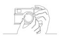 Continuous line drawing of hand holding photo camera making pictures