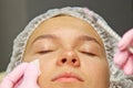 Contour plastic. A cosmetologist injects a botulinum toxin to tighten and smooth out wrinkles on the skin of a female face