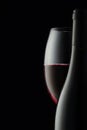 the contours and curves of a bottle and a glass of red wine. a concept for decorating a wine shop or restaurant Royalty Free Stock Photo