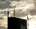 Contours of tower cranes above office building Royalty Free Stock Photo