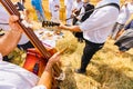Musician plays double bass with wood percussion, bells, music for good harvest