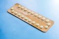 Contraception pills on blue background. Female contraceptives concept. Royalty Free Stock Photo