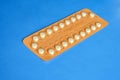 Contraception pills on blue background. Female contraceptives concept. Royalty Free Stock Photo