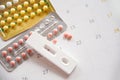 Contraceptive pill and Pregnancy Tests Prevent Pregnancy Contraception concept Birth Control with Condom and roses on calendar