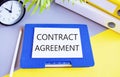 Contract agreement text written on white paper above a Notebook. Concept of legally enforceable agreement between two or more Royalty Free Stock Photo