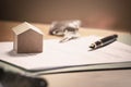 Contract documentation for home mortgage with a pen. Keys and home icon with empty copy space Royalty Free Stock Photo