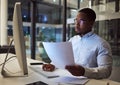 Contract, documents and data with a businessman working at night on a computer in an office. Research, reading and Royalty Free Stock Photo