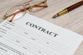 Contract form to fill out on the office Desk with glasses and pen. Working environment in a Bank or business idea Royalty Free Stock Photo