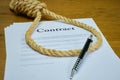 Contract with pen and rope tied in hangmans noose. Strangulation contract, unfair agreement. Lorum Ipsum text Royalty Free Stock Photo