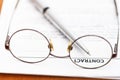 Contract and silver pen through eyeglasses Royalty Free Stock Photo