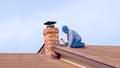 Contractor Builder with blue hardhat repairing roof Royalty Free Stock Photo