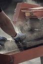 Contractor cutting through a concrete block in a cloud of dust u Royalty Free Stock Photo