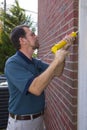Contractor filling exterior wall cracks Royalty Free Stock Photo