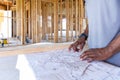 Contractor foreman reviews plans for house construction Royalty Free Stock Photo