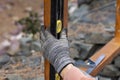 Contractor hanyman using tools to buildi a horizontal fence made from stained cedar