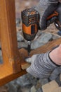 Contractor hanyman using tools to buildi a horizontal fence made from stained cedar