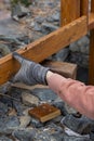 Contractor hanyman using tools to buildi a horizontal fence made from stained cedar