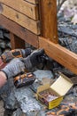 Contractor hanyman using tools to buildi a horizontal fence made from stained cedar