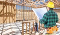 Contractor with hard Hat and Plans Standing In Construction Site Royalty Free Stock Photo