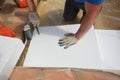 Contractor installing foam insulation on the floor. Bathroom floor layers construction with waterproofing membrane, styrofoam