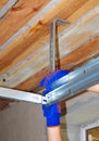 Contractor Installing Garage Door Metal Profil Post Rail and Spring Installation and Garage Ceiling. Royalty Free Stock Photo
