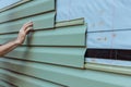 Contractor installing vinyl siding plastic panels on facade wall of a new home Royalty Free Stock Photo
