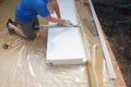 Contractor insulating house foundation floor with rigid foam board insulation with waterproof membrane. Insulated foam sheets for