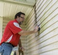 Contractor On Ladder Cleaning Algae And Mold From Vinyl Siding Royalty Free Stock Photo