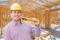 Contractor With Level On Site Inside New Home Construction Framing. Royalty Free Stock Photo