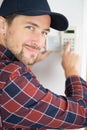 Contractor looking-over-shoulder while using security keypad Royalty Free Stock Photo