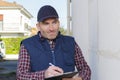 contractor making notes on clipboard while assessing exterior property Royalty Free Stock Photo